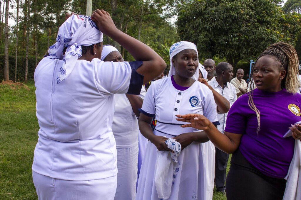 Women in White and Purple Attire